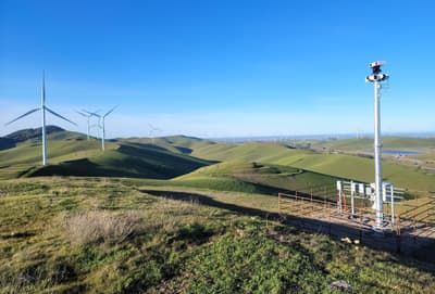 A monitoring system (right) uses A.I. to determine if birds are in danger of colliding with turbines in Alameda County, California.