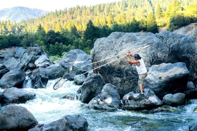 A Karuk tribal member fishes for salmon on the Klamath River.